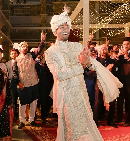 The groom's grand entry, dancing his way in, surrounded by the cheers of his family and friends.