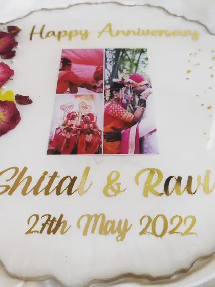 Making orders, making memories for someone. This anniversary platter features the couple's photos, names, and wedding date, surrounded by preserved rose petals.