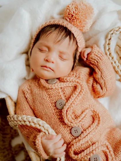 A peaceful slumber in a cozy basket. The soft textures and warm tones make this newborn photo feel so serene.