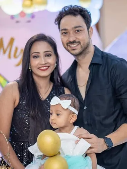 Another lovely family photo from the birthday celebration, capturing the parents' pride and joy.