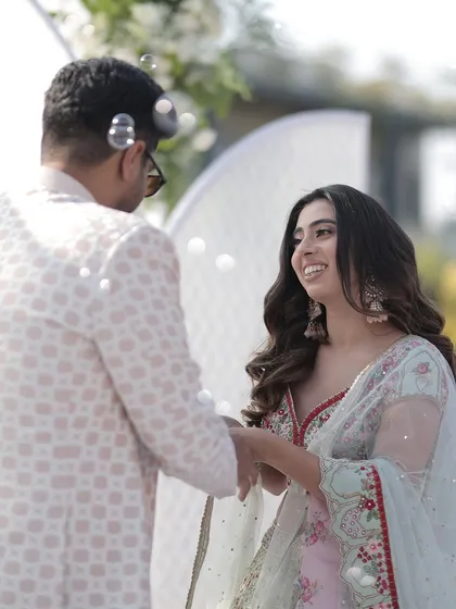 The bride's happy face says it all. A close-up of the couple during their ring ceremony.