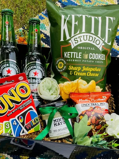 A fun and casual hamper perfect for a game night. It includes Heineken beer, Kettle cooked chips, mint mayo, a spicy trail mix, and a deck of UNO cards.