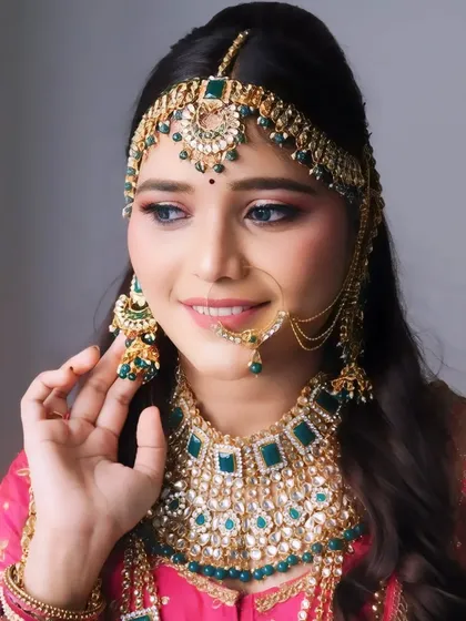 A stunning North Indian bridal look, featuring a radiant smile and beautifully defined eyes. The focus here is on creating a glamorous yet timeless appearance that looks incredible in photographs.