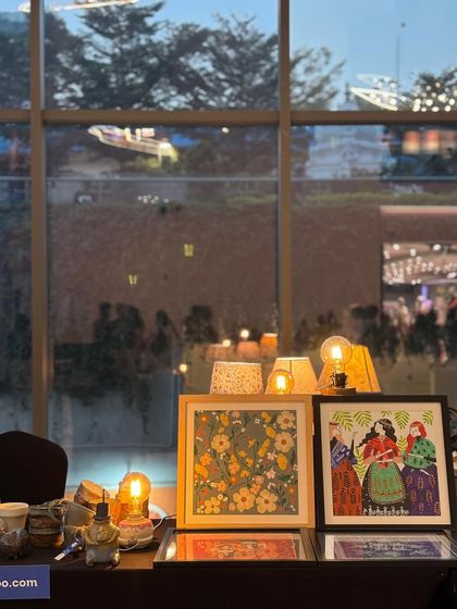 Our stall at the Lulu Mall flea market, glowing warmly as evening sets in. The lamps and artwork created a beautiful, inviting display.