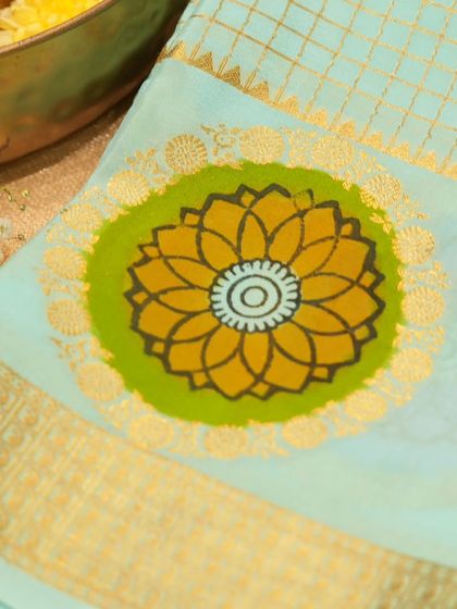 The vibrant, large floral motif on the Mysore silk saree, a hallmark of this traditional weave.