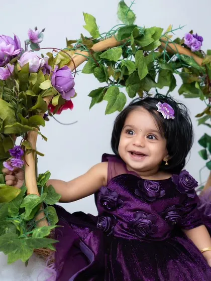 Every milestone is worth celebrating, from their first smile to sitting up on their own. This sitter session features a beautiful floral swing prop, one of over 100 creative setups available in my studio to capture your baby's unique personality.