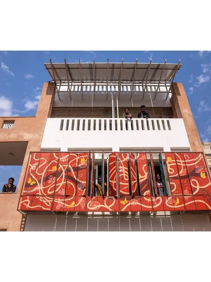 The vibrant facade of the Butterflies Centre in Delhi. These hand-painted louvers are not just for decoration; they are a dynamic shading system that controls sunlight. This is an example of how we integrate art with function to create buildings that are both beautiful and intelligent.