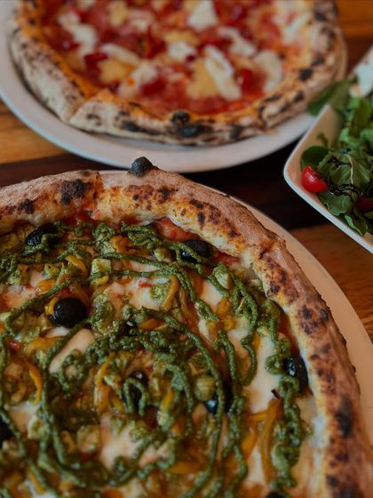 A beautiful spread of our pizzas and a fresh salad. Perfect for sharing with friends.