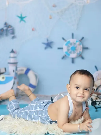 A relaxed moment during the nautical shoot, with the baby boy lying down and looking so content.