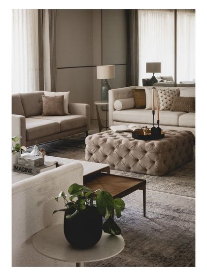 Details matter. Here, a collection of books, plants, and candles on the coffee tables adds a personal, lived-in feel to the formal living area.