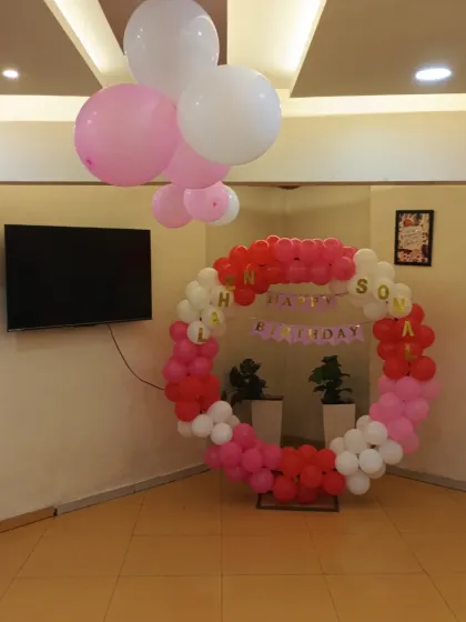 A wide view of the party hall with our pink, red, and white balloon ring decoration.