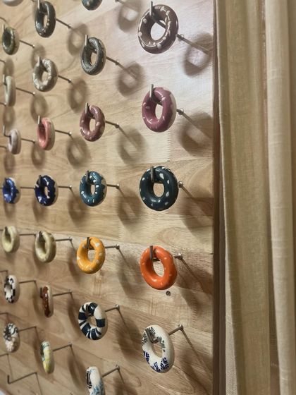 A peek into our glaze room, showing our wall of test tiles. We're constantly experimenting with new colors and combinations to offer our students a wide range of options.