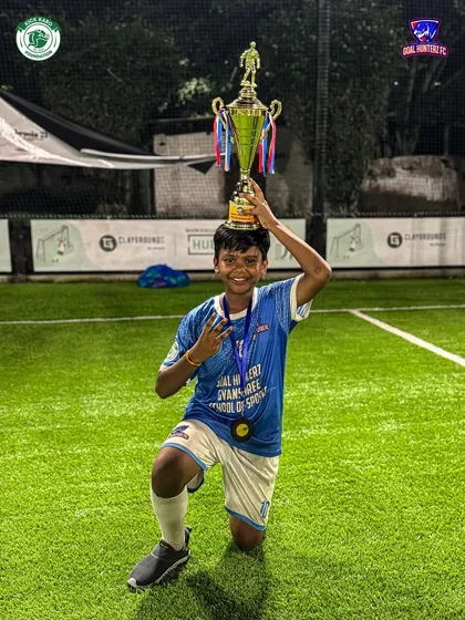 A young champion balancing the trophy on his head after our U-13 boys finished as 2nd Runners-up in the Jr. Gladiator Cup.