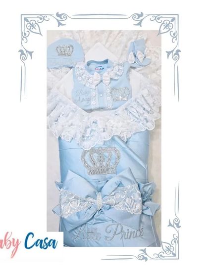 A stunning "Little Prince" set in baby blue. The wrap features a large bow with lace details, and the matching romper is adorned with bows and a sparkling crown for a coordinated look.