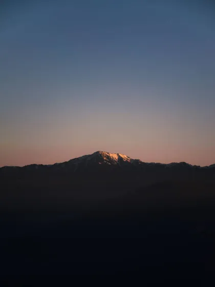 the last light of sunset on a mountain peak. this minimal color palette shows how effective a simple, focused use of color can be.