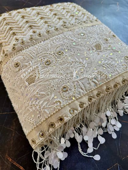 Another close-up of the pallu, focusing on the texture of the crepe fabric and the density of the hand-embroidery.