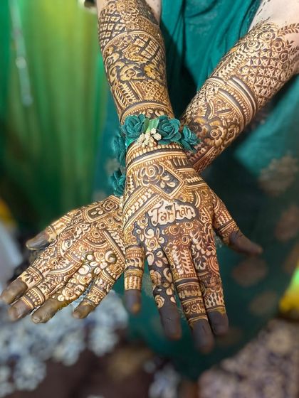 This bridal design includes the bride's name, 'Farhin', beautifully integrated into the floral patterns on her palm.