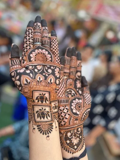 A stunning design with bold, dark henna, featuring lotus motifs in square frames.
