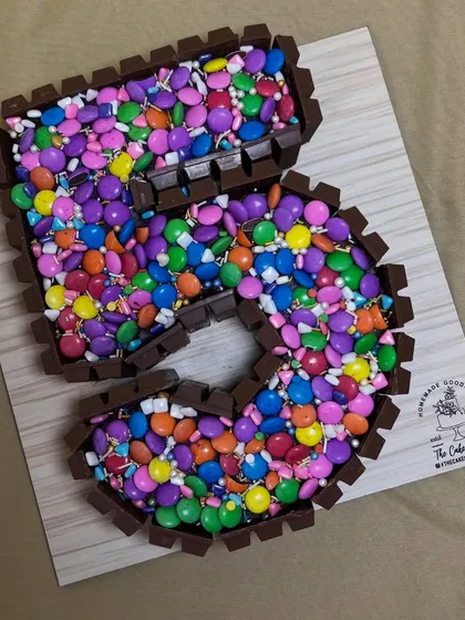 A classic for any chocolate lover, this number 5 cake features a KitKat border holding in a sea of colorful Gems. It's a fun, crunchy, and delicious centerpiece that's always a hit at children's parties.