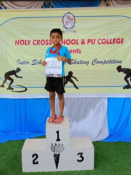 Our young champ Reyansh standing proud on the first-place podium after winning a gold medal at the Holy Cross School inter-school competition.