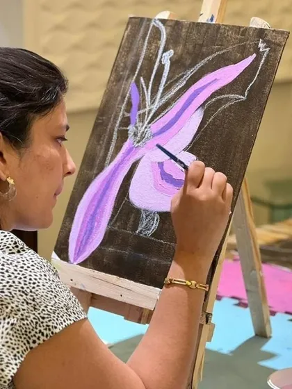 An adult participant enjoying our Georgia O'Keeffe workshop. My classes are for everyone, and it's wonderful to see people of all ages finding their creative flow.