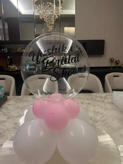 It's all in the details. This personalized balloon centerpiece for a bridal shower adds a special touch to the table setting, welcoming guests to the celebration.