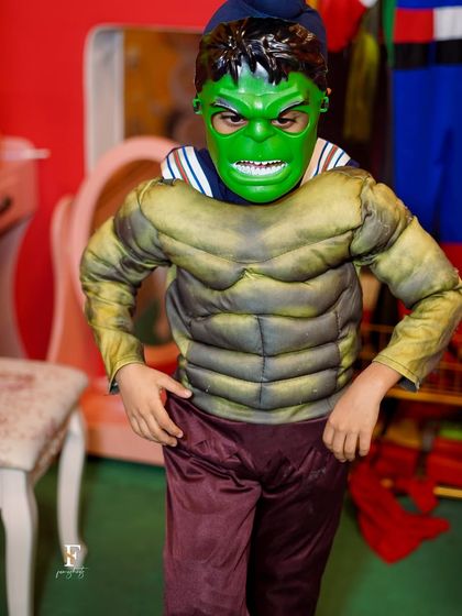 A young guest fully embraces his role as the Hulk. Our high-quality costumes and masks help children immerse themselves in imaginative play during our themed parties.