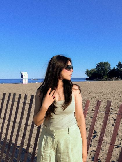 A golden hour shot at the beach, with a simple, chic summer outfit.