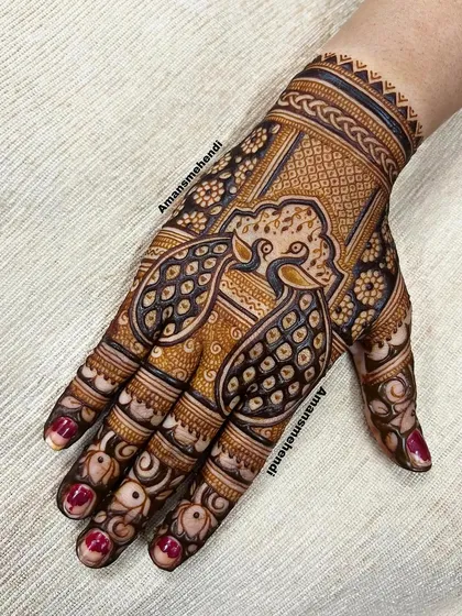 A bold back-of-hand design featuring a large, stylized peacock. The intricate details and use of negative space make this a very striking piece.