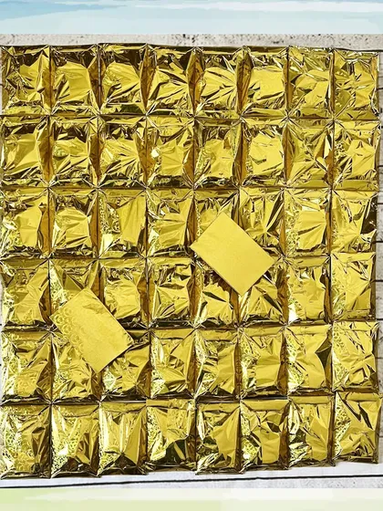 A large batch of erasers, all wrapped in gold foil for a uniform and elegant look, perfect for a more formal event.
