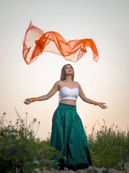 From my conceptual Republic Day shoot. This image captures the creative styling and makeup, featuring a bold smokey eye and a look inspired by the Indian tricolor, complete with a flowing orange dupatta for a dynamic effect.