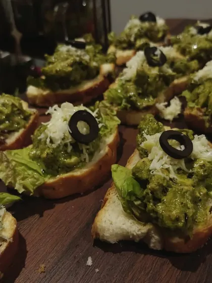 To add a global touch to your menu, I offer appetizers like this Pesto Chicken Bruschetta. It features toasted bread topped with savory pesto, tender chicken, and fresh cheese, making for a perfect bite-sized snack for any occasion.