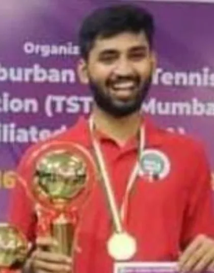 A close-up of our men's champion, Ravindra Kotiyan, smiling with his winner's trophy. His victory at the state level is a huge inspiration for our younger players.