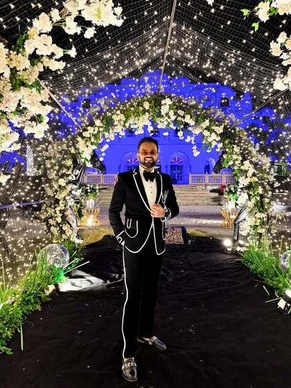 A classic black and white tuxedo for a sangeet night in Jaipur. This look is timeless and perfect for a glamorous cocktail event or a corporate awards gala.