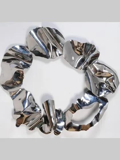 A full view of the circular loop sculpture, an early exploration into creating continuous forms from fragmented parts.