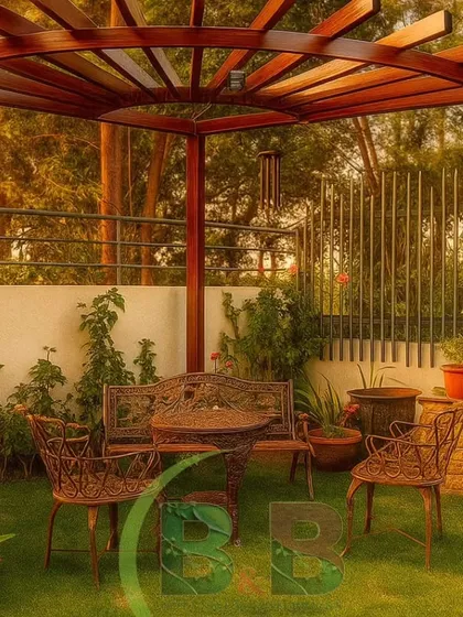 A perfect corner for quiet afternoons. We designed this tranquil garden space in Bannerghatta with a lush lawn, classic wrought-iron seating, and a custom-built wooden pergola that provides dappled sunlight, creating an idyllic and timeless retreat.