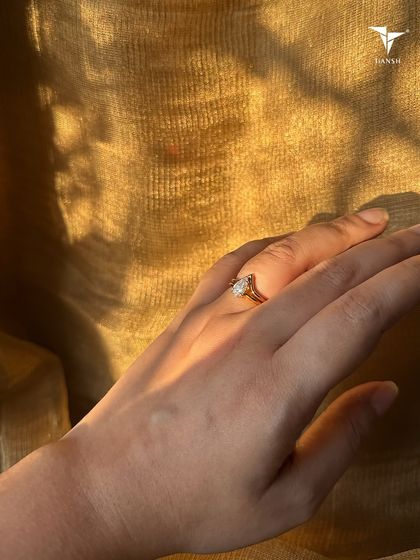 A beautiful heart shaped diamond solitaire ring, catching the golden hour light. A classic symbol of love and romance, perfect for a special commitment.