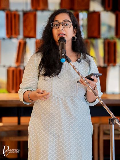 A poet stands at the mic, sharing her verses with the audience. Each performer brings a unique energy and perspective to our gatherings, making every event special.