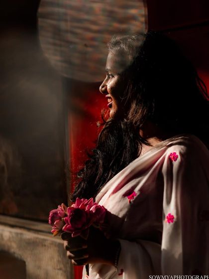 The beautiful morning light hitting her face as she holds a bouquet of lotuses. This shot was taken during a street style couple shoot in old Bangalore.