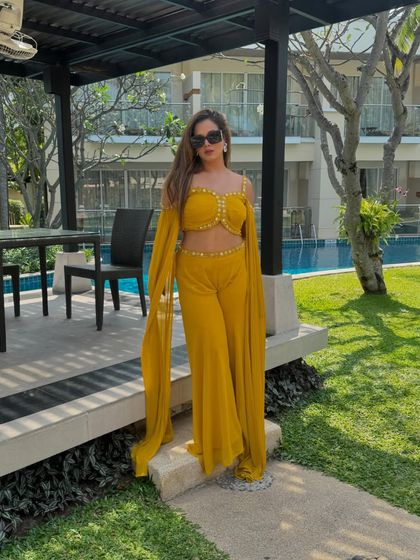 Posing by the pool in Thailand before hosting a fun-filled Haldi. My style adapts to the location, bringing a chic and tropical vibe to this international wedding.