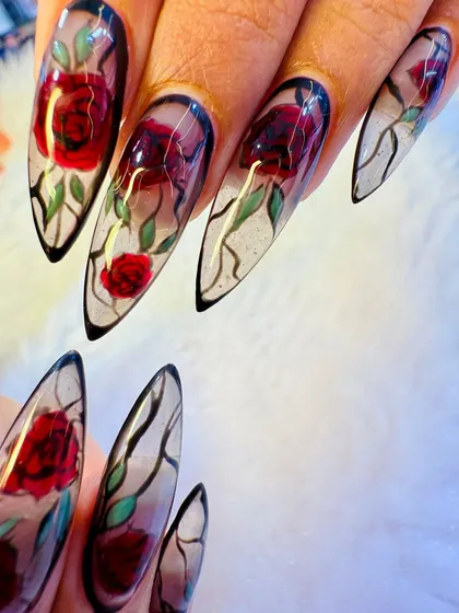 For the bride who wants something truly unique, we crafted this stained-glass rose design. Each nail is a piece of art, featuring sharp, stiletto-shaped extensions with a translucent base and hand-painted floral details that catch the light beautifully.