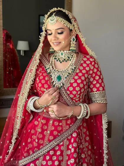 A candid moment showing the bride's beautiful smile and the intricate details of her jewelry and makeup. The soft glam look ensures she looks like herself, but elevated.