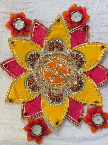 This floral rangoli platter is a beautiful and mess-free alternative to traditional rangoli. The vibrant fabric petals and central urli create an instant festive centerpiece for your floor or table.