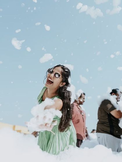 Pure fun! A bride enjoying a foam party with her friends, a unique and memorable pre-wedding celebration.