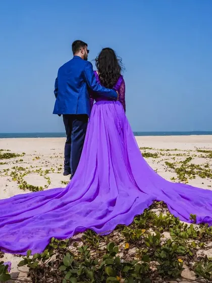 Create unforgettable pre-wedding memories with a dramatic beach photoshoot. This flowing lavender tail gown looks incredible against the open sky and coordinates beautifully with our rental blazers for men.