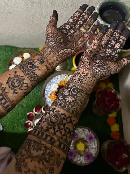 A close-up of this bride's detailed mehendi. The design includes personalized elements and traditional motifs, perfect for her wedding day.
