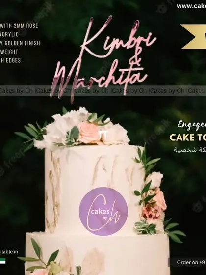 A mockup of a "Kimbri & Marchita" topper on a beautiful floral cake, showing how a rose gold finish can complement soft color palettes.