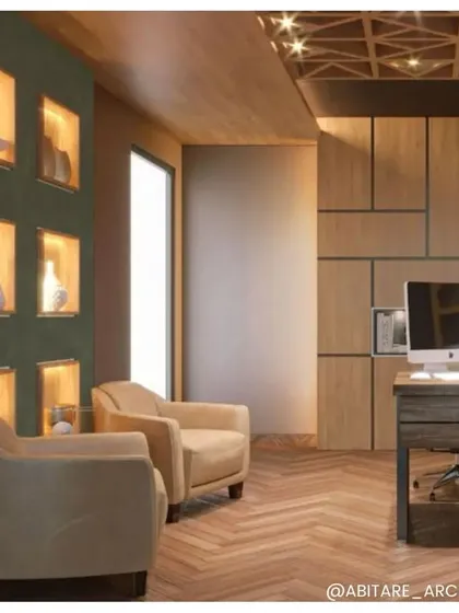 A cozy corner in an office featuring warm wood paneling and comfortable armchairs. The built-in, backlit shelving provides both storage and a beautiful display feature, adding warmth and texture to the room.