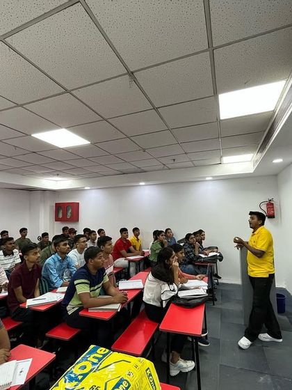 A teacher explains a complex topic on the digital board at our Delhi campus. We ensure every concept is crystal clear.