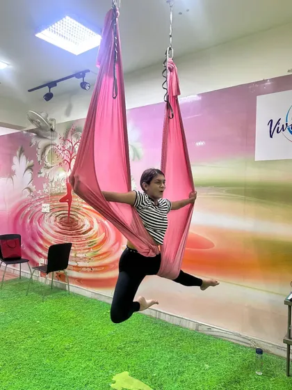 Unfolding your wings and learning to fly. This beautiful aerial split pose showcases the grace and strength that comes with practice. It's a wonderful hip and hamstring opener.